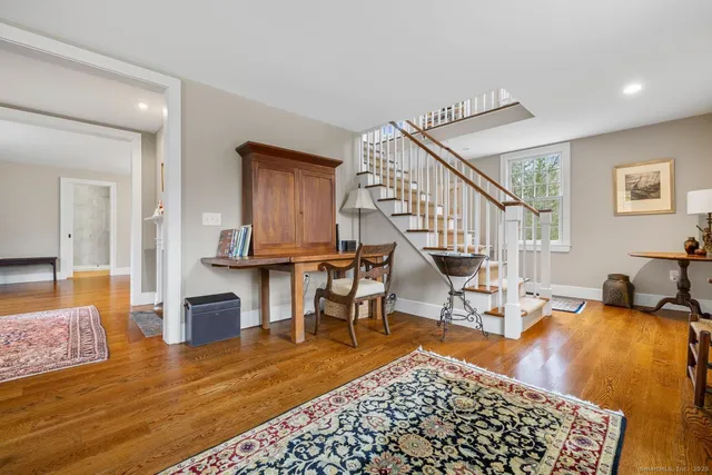 a living room with furniture rug and a table