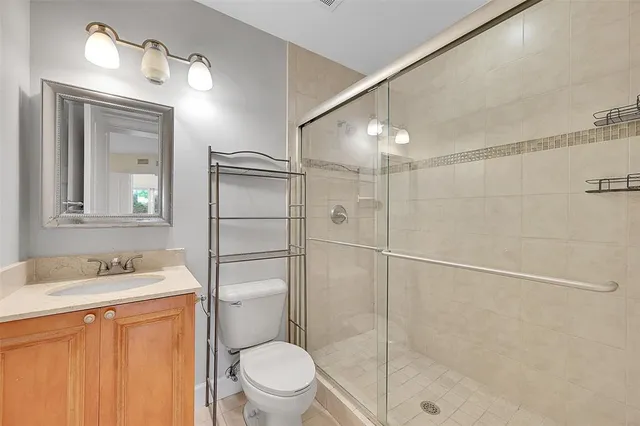 a bathroom with a sink toilet and shower