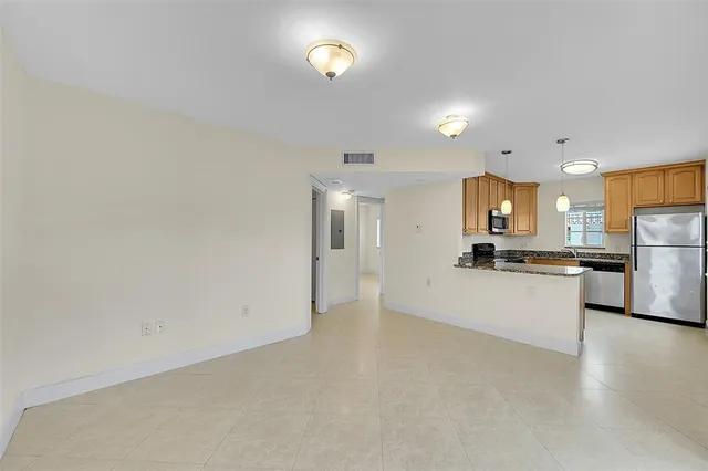 a view of a kitchen with a sink and a refrigerator