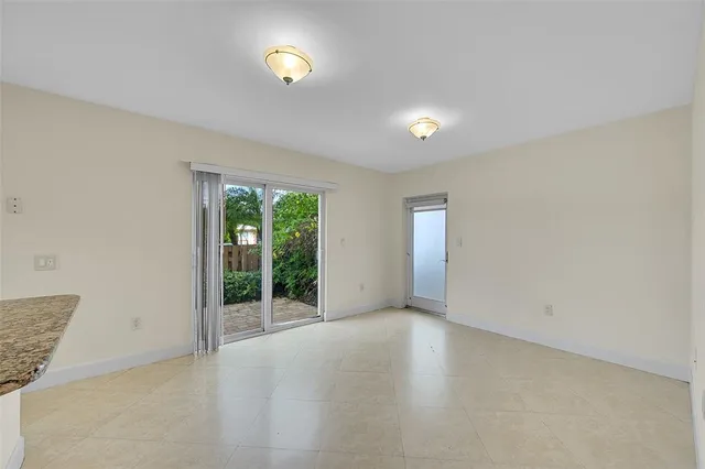 an empty room with windows and entrance