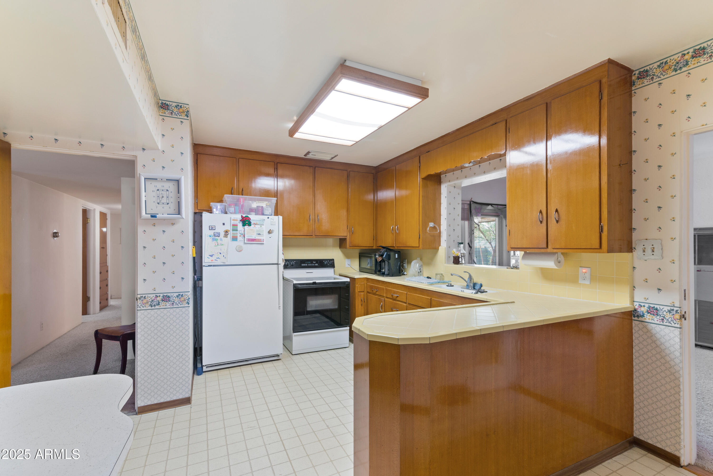 6850 North 15th Place Phoenix, AZ 85014 - Photo 8 of 26 a kitchen with stainless steel appliances kitchen island a sink cabinets and wooden floor