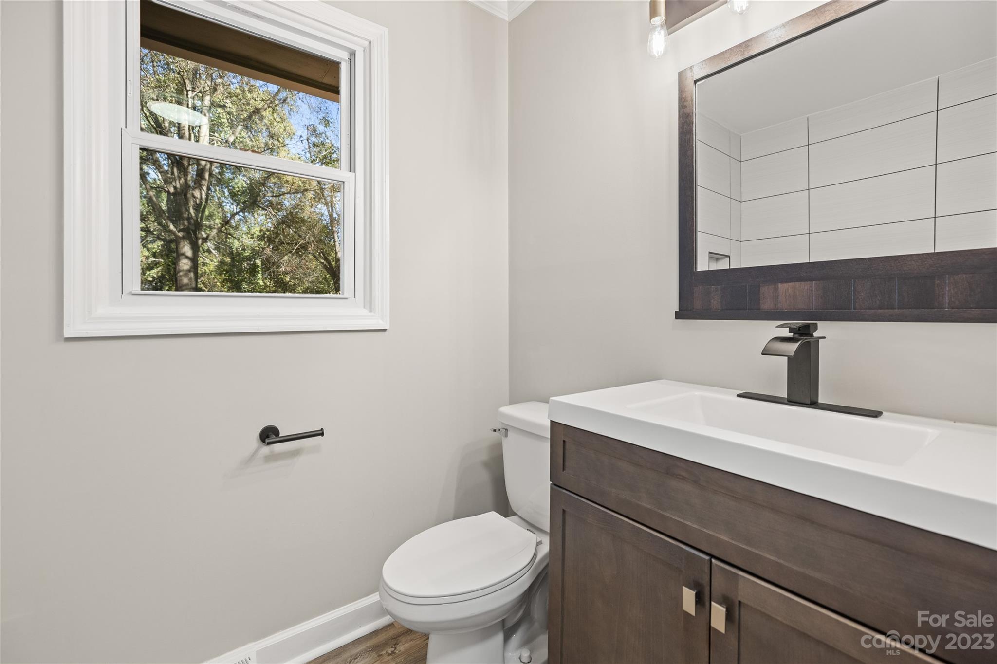 1415 East Main Street Cherryville, NC 28021 - Photo 13 of 34 a bathroom with a sink a toilet and a window