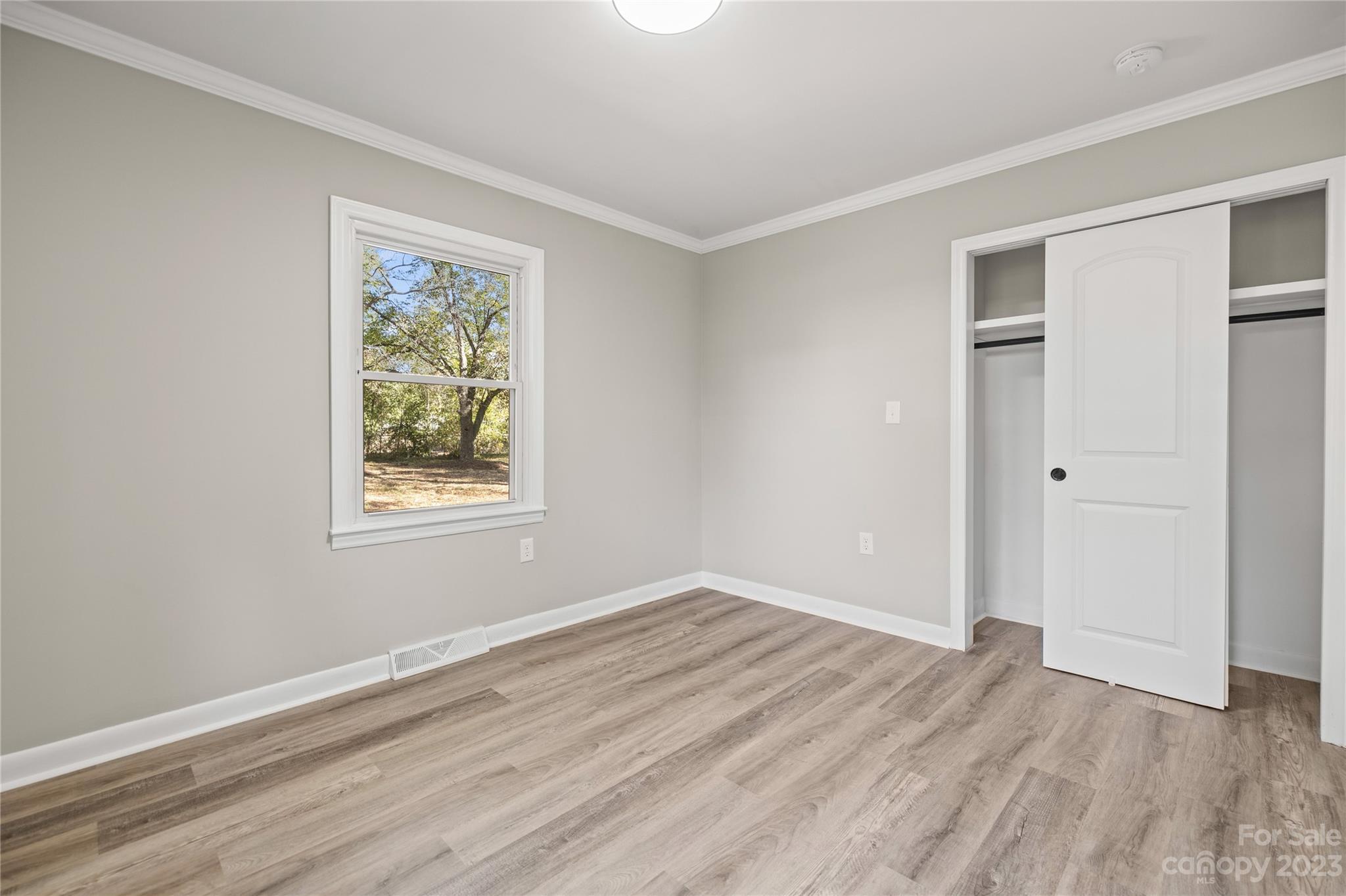 1415 East Main Street Cherryville, NC 28021 - Photo 19 of 34 a view of empty room with wooden floor and fan
