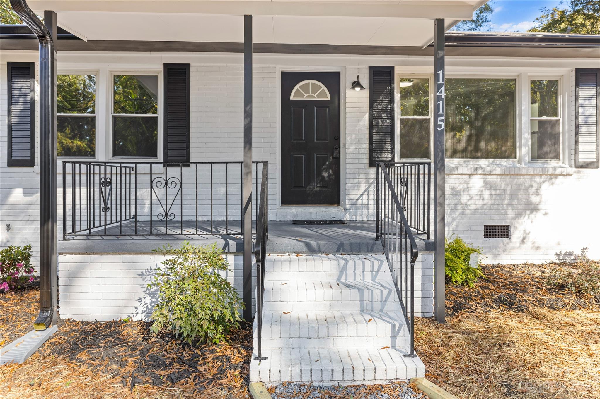 1415 East Main Street Cherryville, NC 28021 - Photo 22 of 34 a front view of a house with a garden