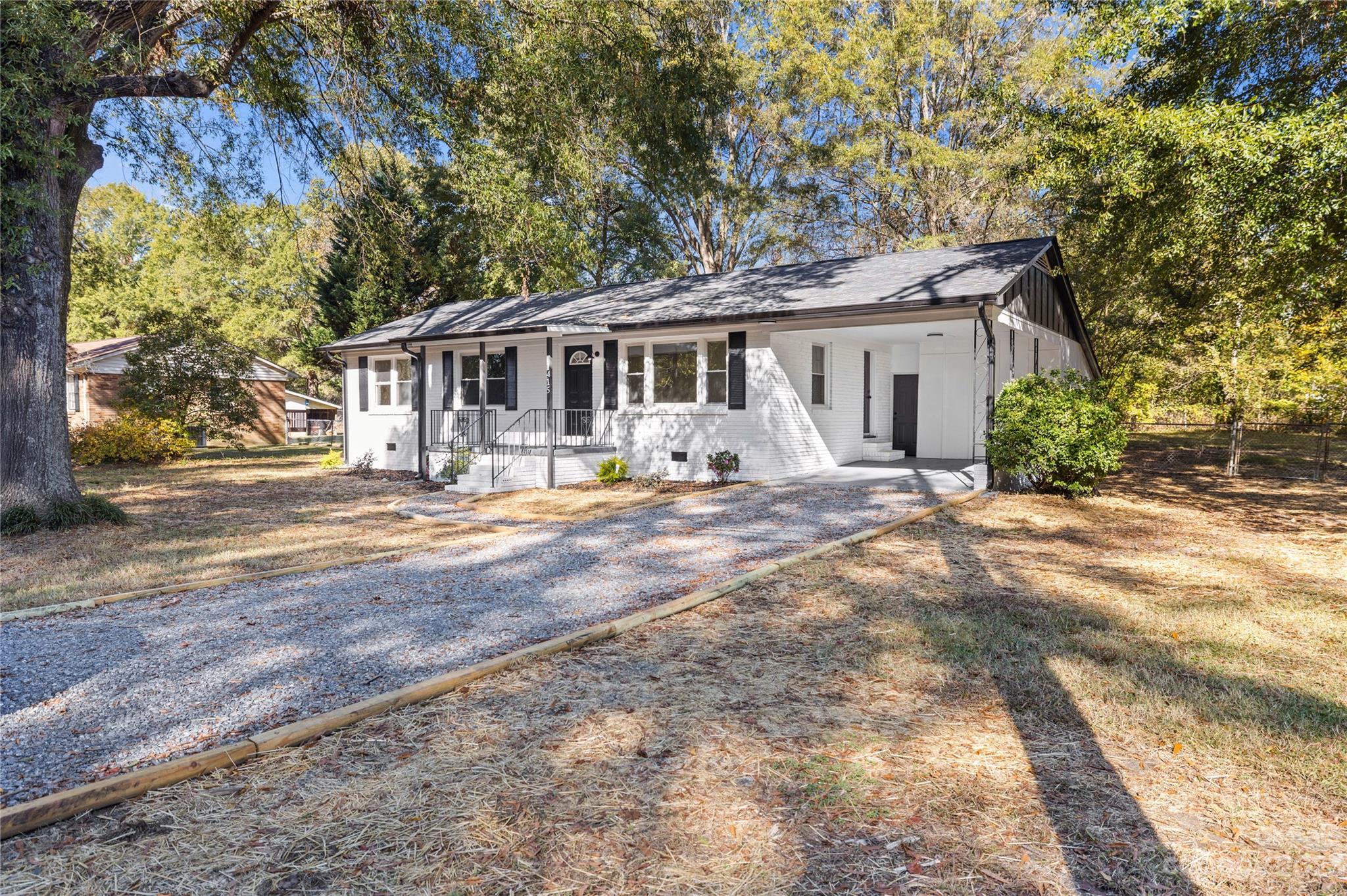1415 East Main Street Cherryville, NC 28021 - Photo 24 of 34 a front view of a house with yard porch and outdoor seating