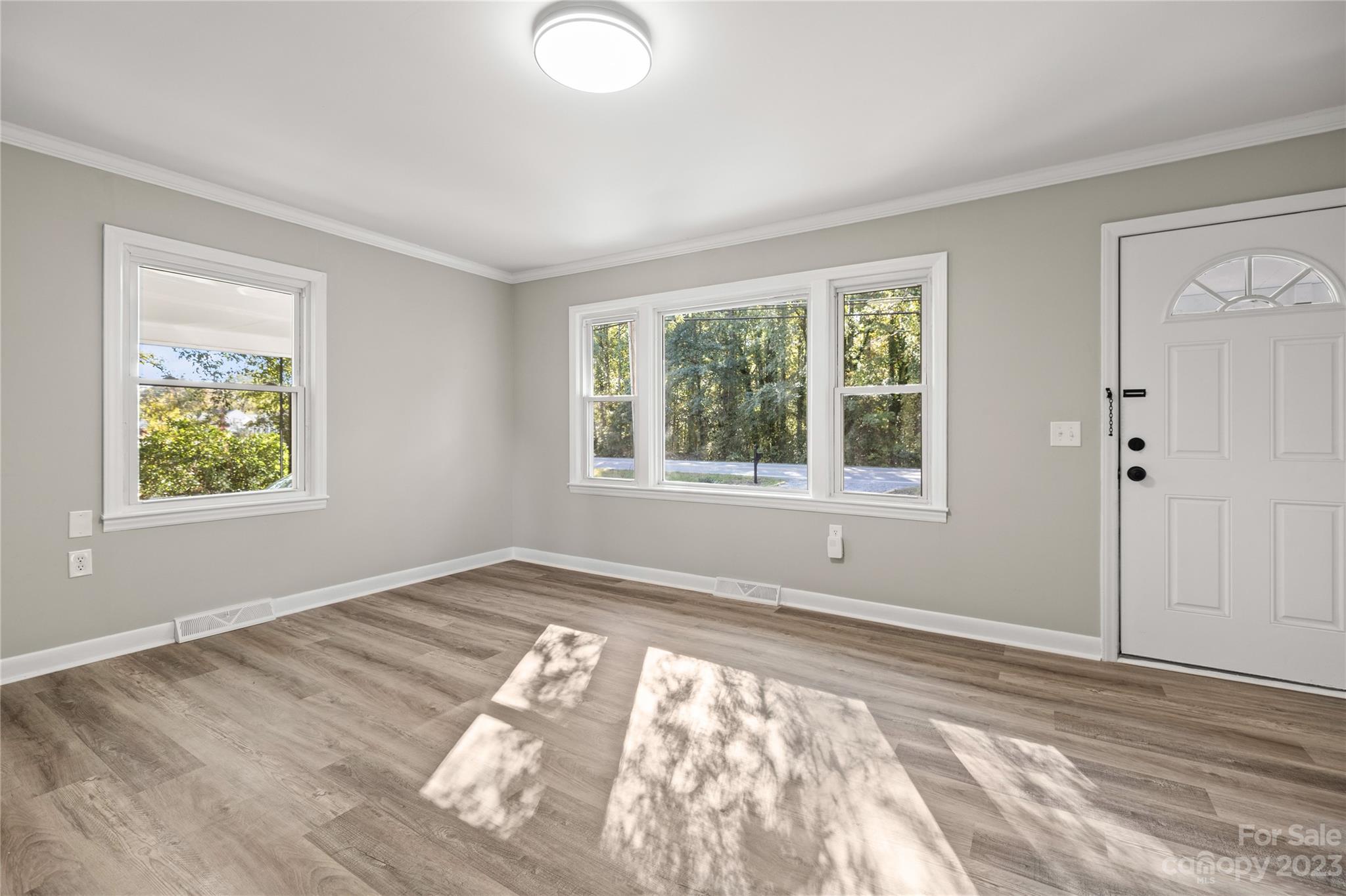 1415 East Main Street Cherryville, NC 28021 - Photo 6 of 34 a view of an empty room with wooden floor and a window