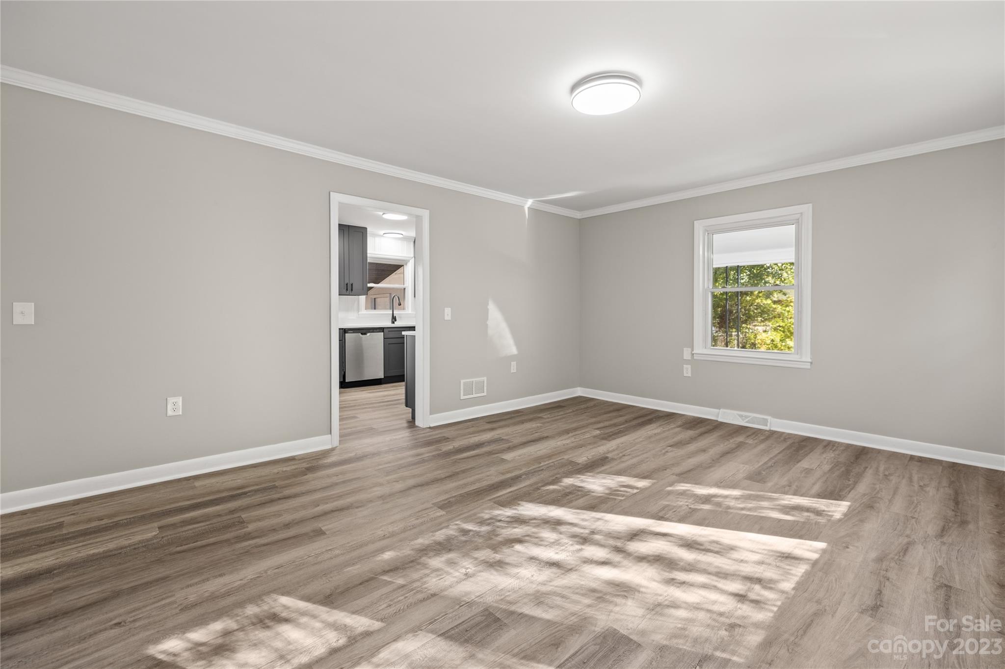 1415 East Main Street Cherryville, NC 28021 - Photo 7 of 34 a view of an empty room with window and wooden floor