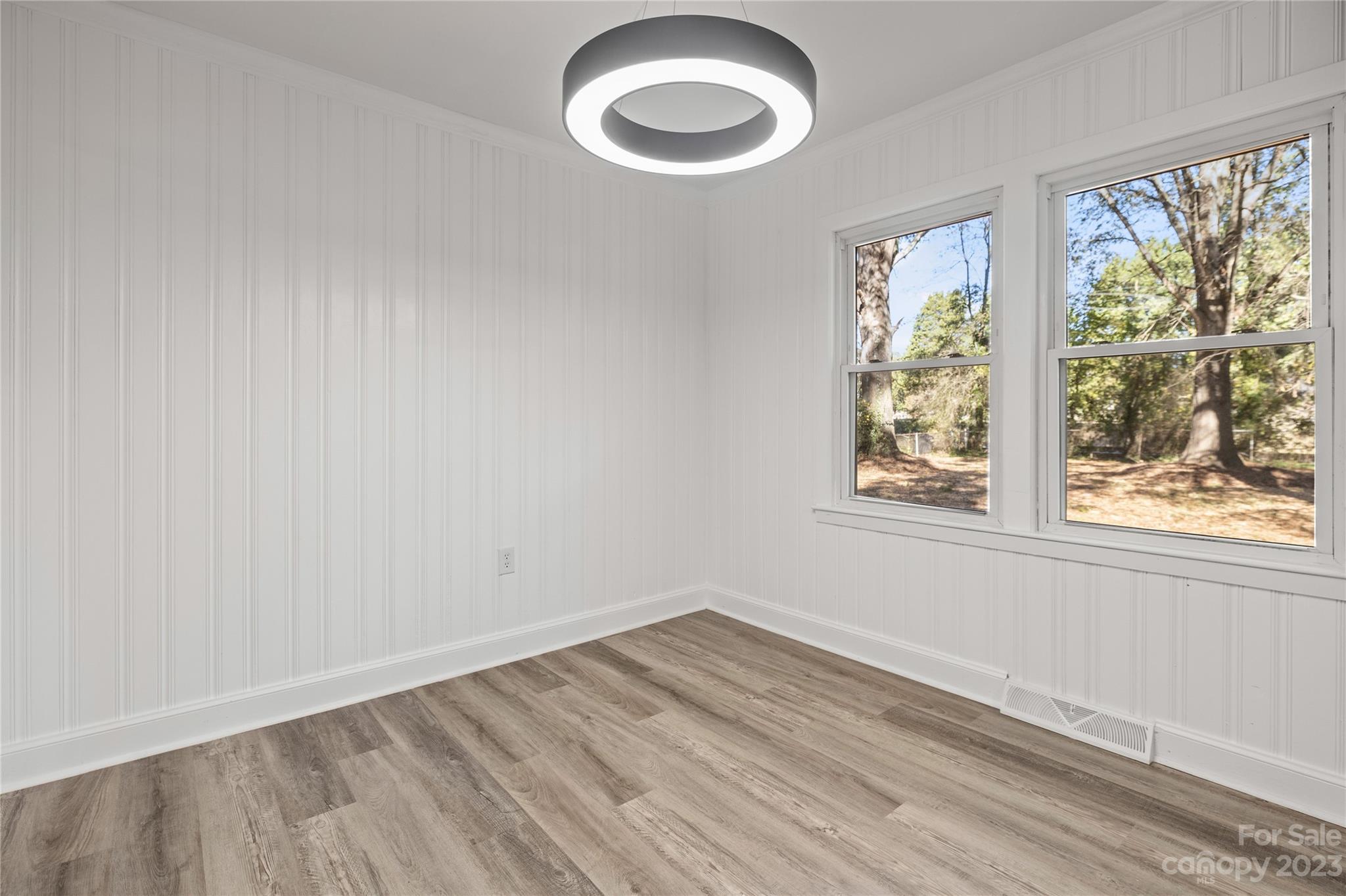 1415 East Main Street Cherryville, NC 28021 - Photo 10 of 34 an empty room with wooden floor and windows