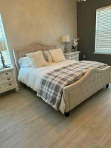 a bedroom with a bed and a dresser