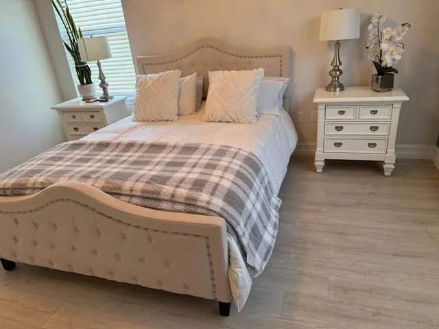 a kitchen with stainless steel appliances a dining table chairs microwave and sink