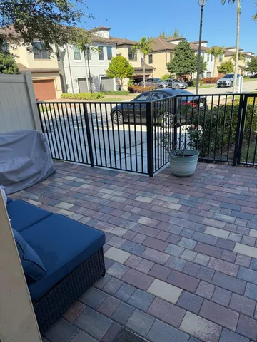 a view of backyard with wooden fence