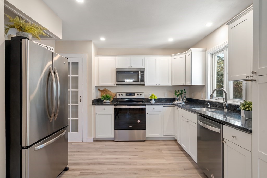 3 Silverbrook Road Boxford, MA 01921 - Photo 5 of 39 a kitchen with granite countertop a refrigerator stove and microwave