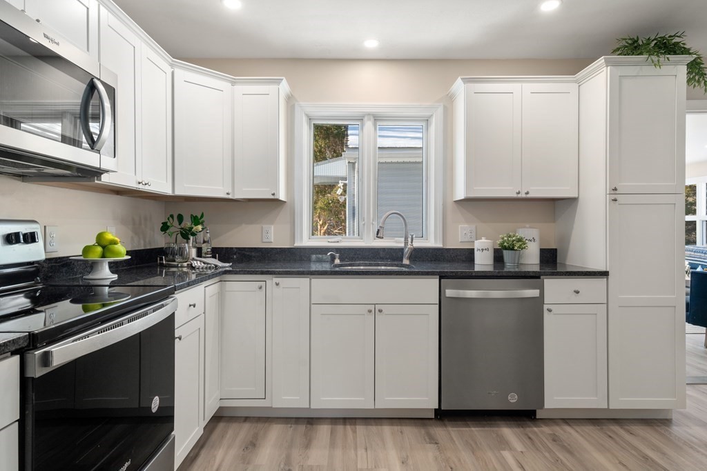 3 Silverbrook Road Boxford, MA 01921 - Photo 6 of 39 a kitchen with stainless steel appliances granite countertop white cabinets sink and stove