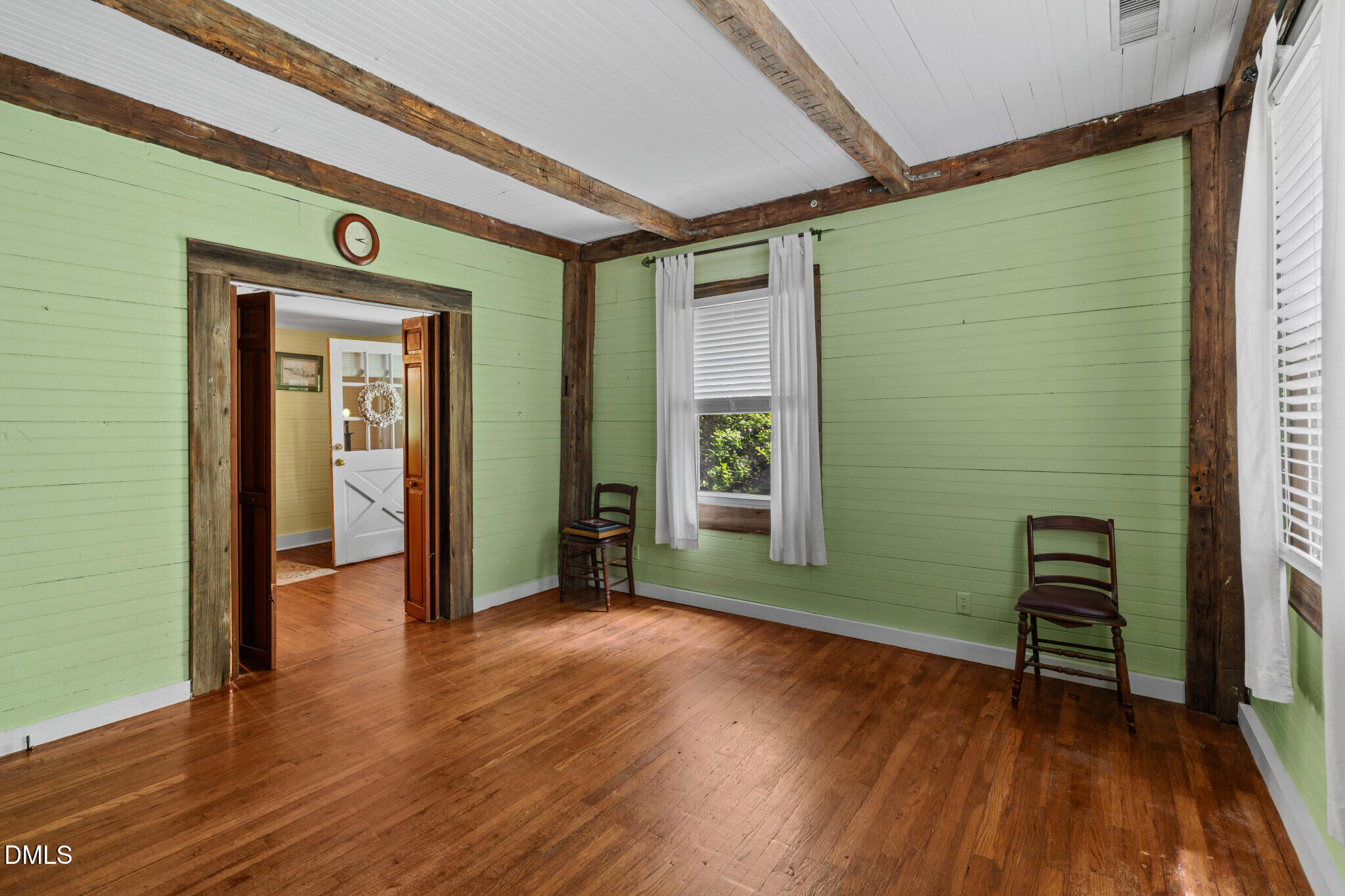 3415 Mt Willing Road Efland, NC 27243 - Photo 4 of 36 a view of an empty room with wooden floor and a window