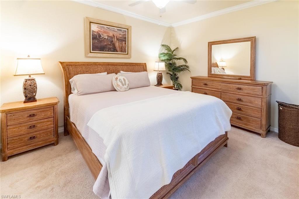 9731 Acqua Court, Unit 536 Naples, FL 34113 - Photo 15 of 47 a bedroom with a bed and a dresser