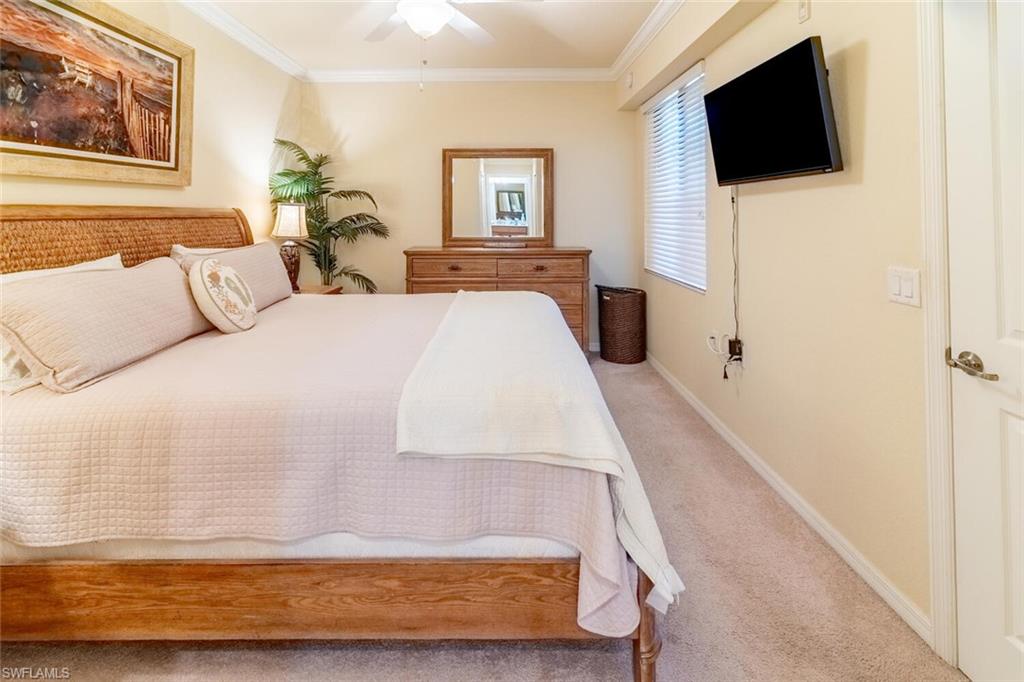 9731 Acqua Court, Unit 536 Naples, FL 34113 - Photo 17 of 47 a bed room with a bed a tv and a window