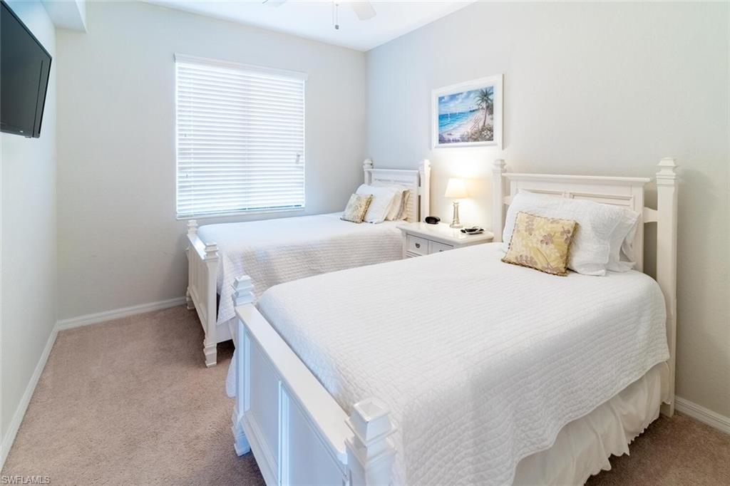 9731 Acqua Court, Unit 536 Naples, FL 34113 - Photo 20 of 47 a bedroom with a bed and a window