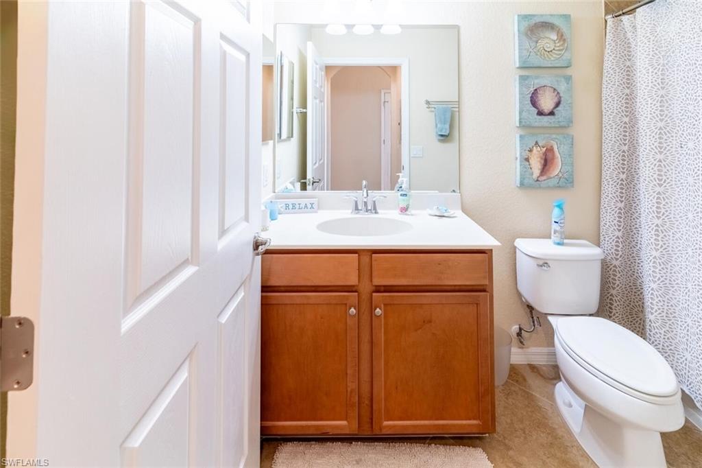 9731 Acqua Court, Unit 536 Naples, FL 34113 - Photo 22 of 47 a bathroom with a sink a toilet and vanity