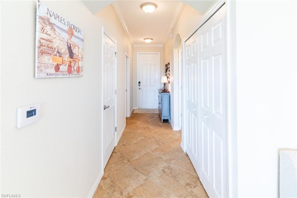 9731 Acqua Court, Unit 536 Naples, FL 34113 - Photo 4 of 47 a view of a hallway with a white walls