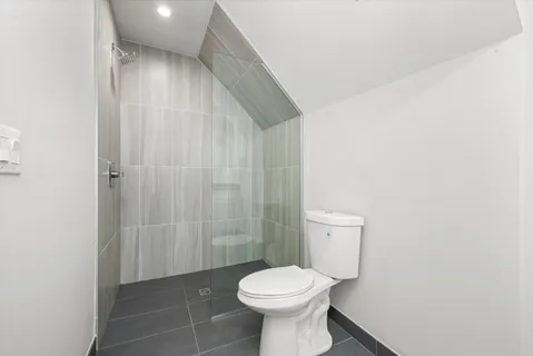 a spacious bathroom with a granite countertop sink and a mirror