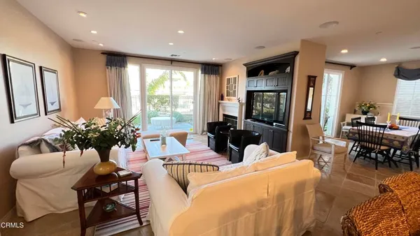 a living room with fireplace furniture and a flat screen tv