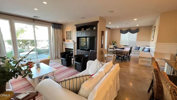a living room with furniture fireplace and a large window