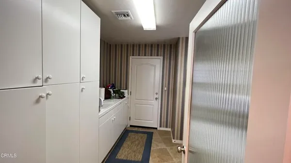 a kitchen with a refrigerator and a sink