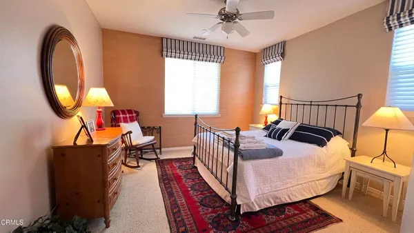 a bedroom with bed and a chandelier