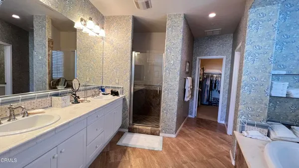 a bathroom with a double vanity sink and a mirror