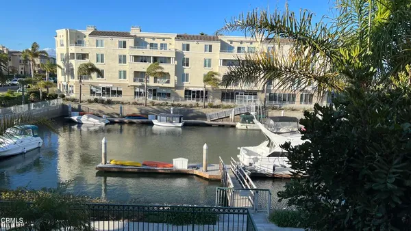 a view of a swimming pool with outdoor seating and plants