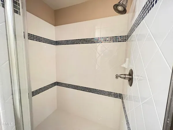 a bathroom with a shower and a shower
