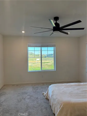 a bed sitting in a room next to a window