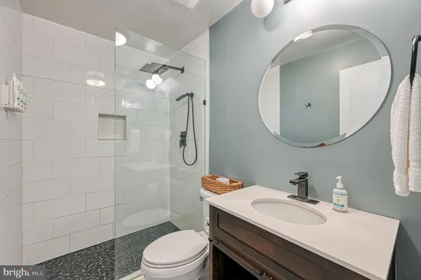a bathroom with a glass shower door