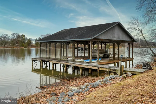 an aerial view of residential houses with outdoor space and lake view