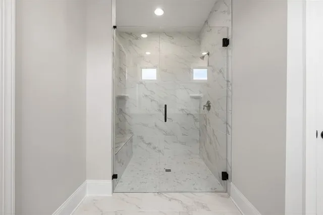 a spacious bathroom with a granite countertop sink mirror and shower