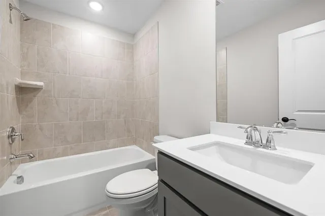 a view of an empty room with wooden floor and a large window