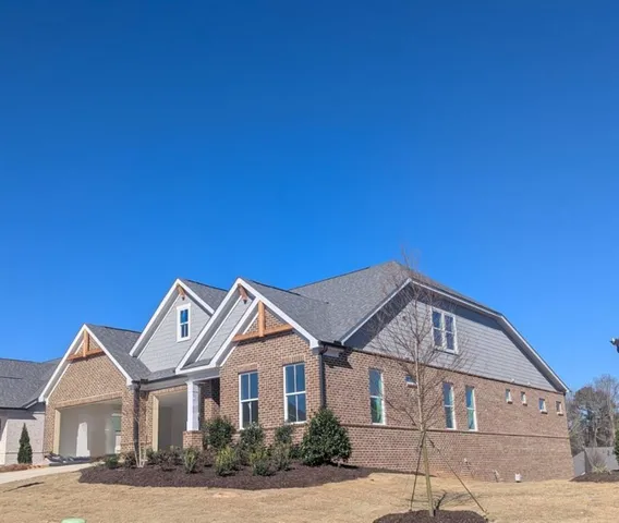 a front view of a house with a garden