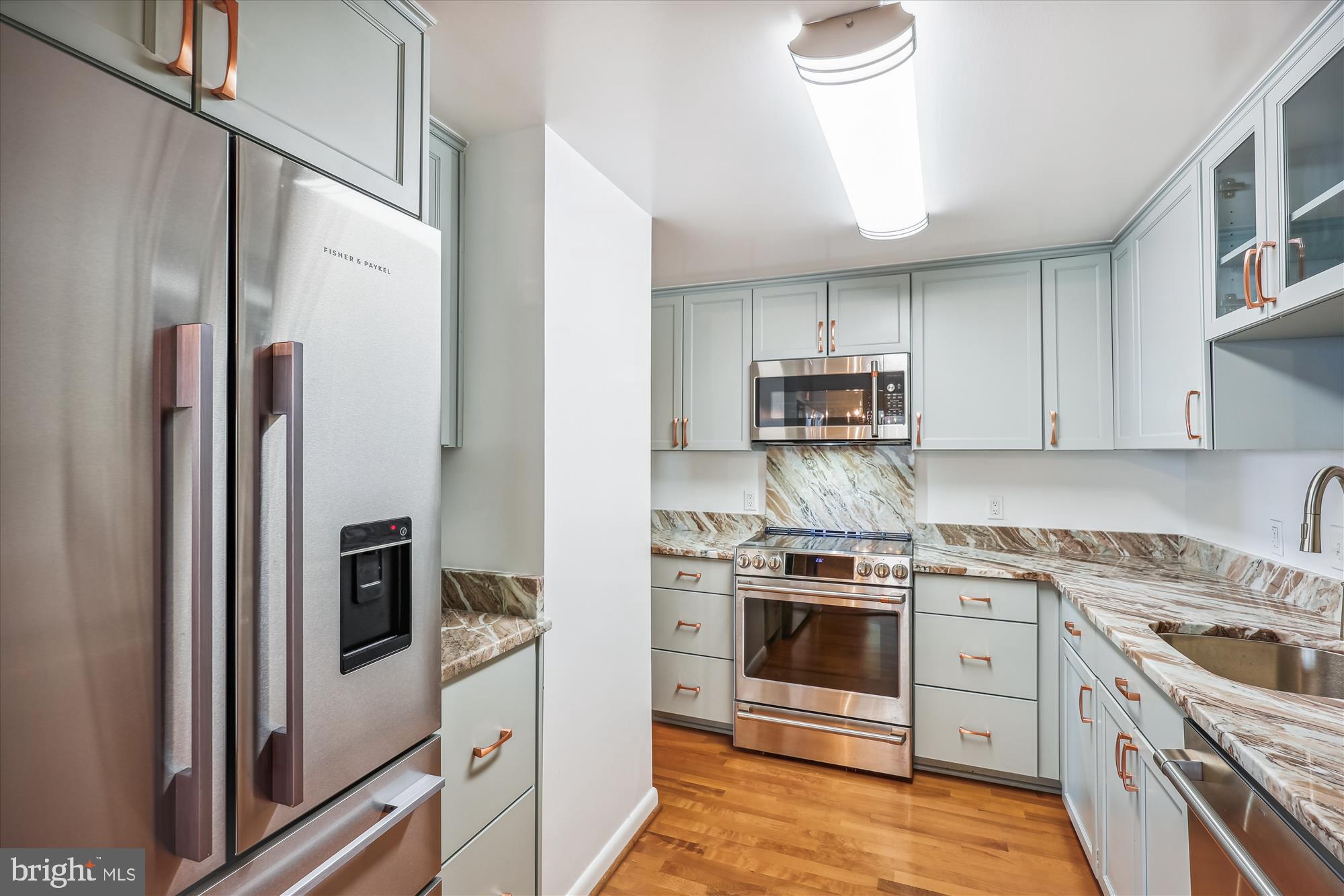 a kitchen with stainless steel appliances granite countertop a stove sink and refrigerator
