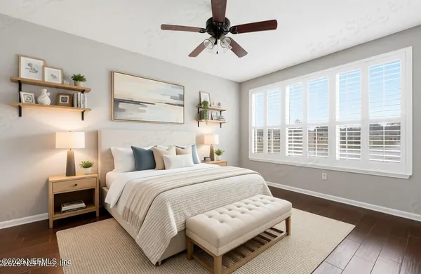 a bedroom with a bed furniture and a large window