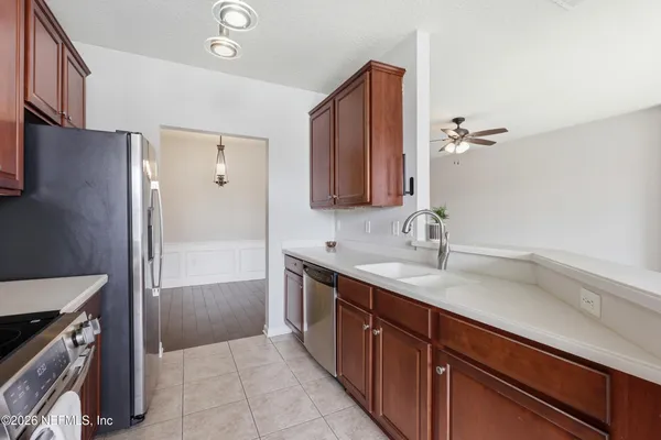a kitchen with stainless steel appliances granite countertop a stove a microwave and a refrigerator