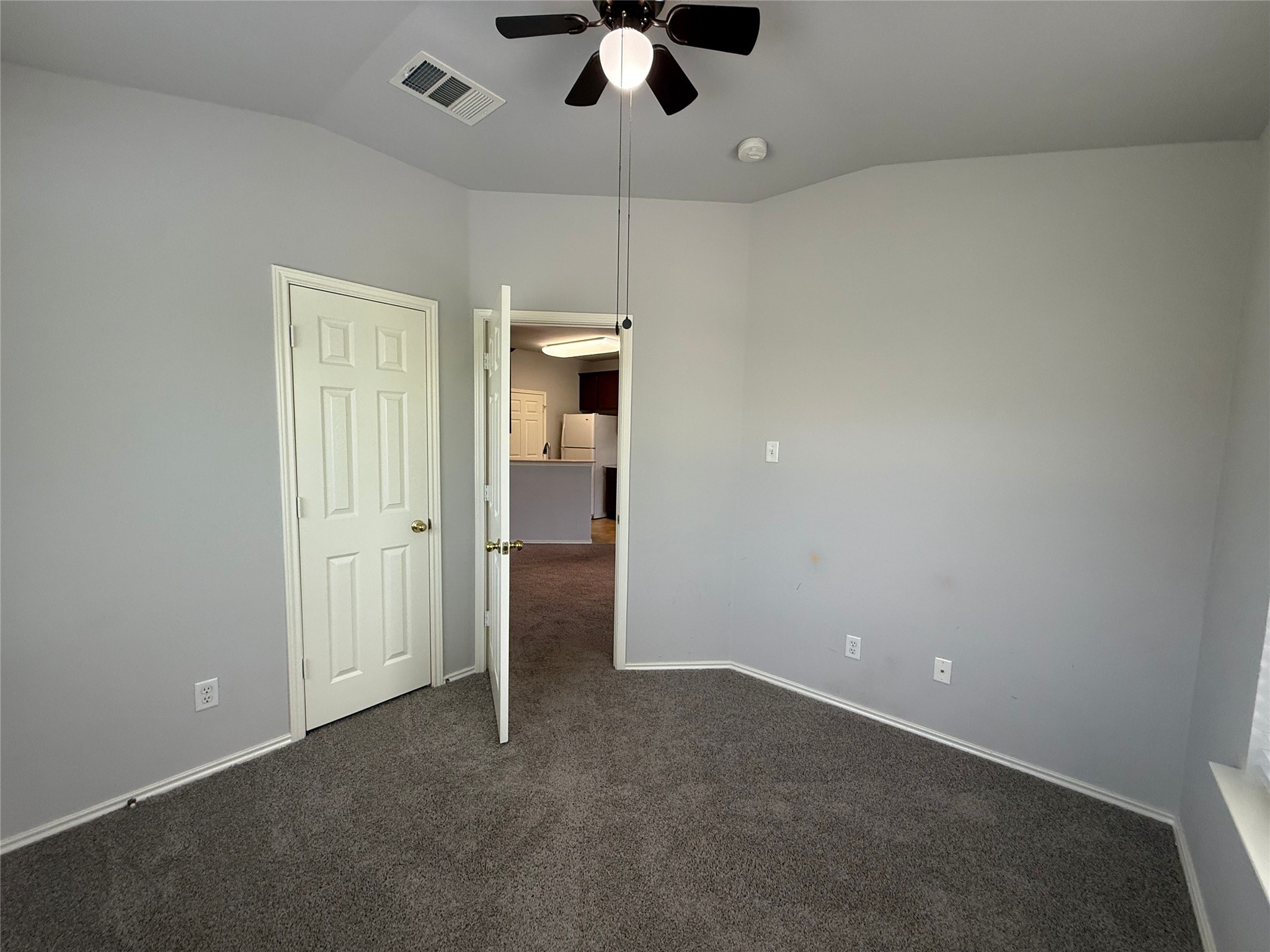 1900 Scofield Ridge Parkway, Unit 4701 Austin, TX 78727 - Photo 11 of 27 A versatile space features soft carpeting, light gray walls, and a convenient ceiling fan.
