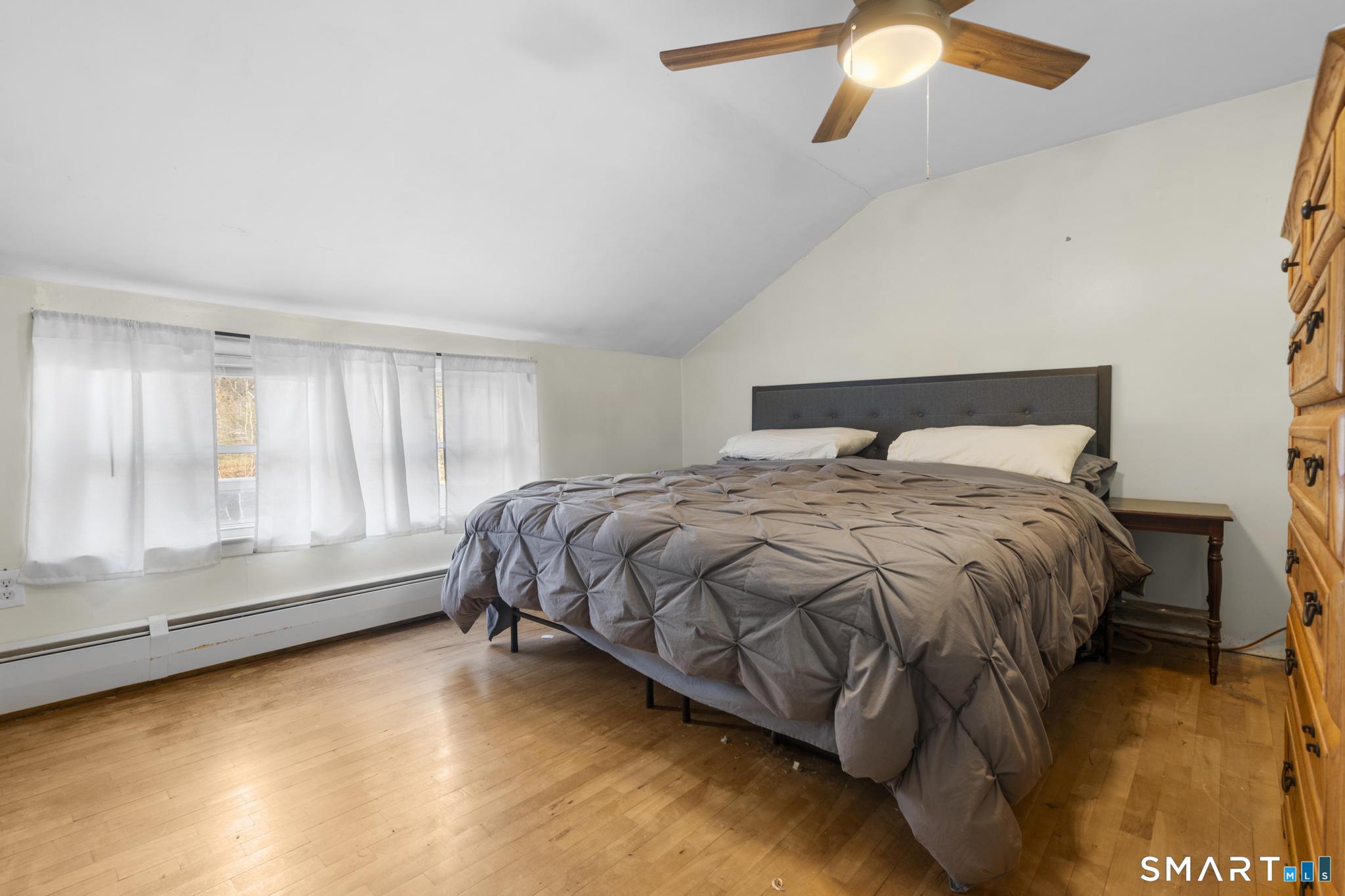 89 Green Meadow Road Milford, CT 06461 - Photo 14 of 31 a spacious bedroom with a bed and a chandelier