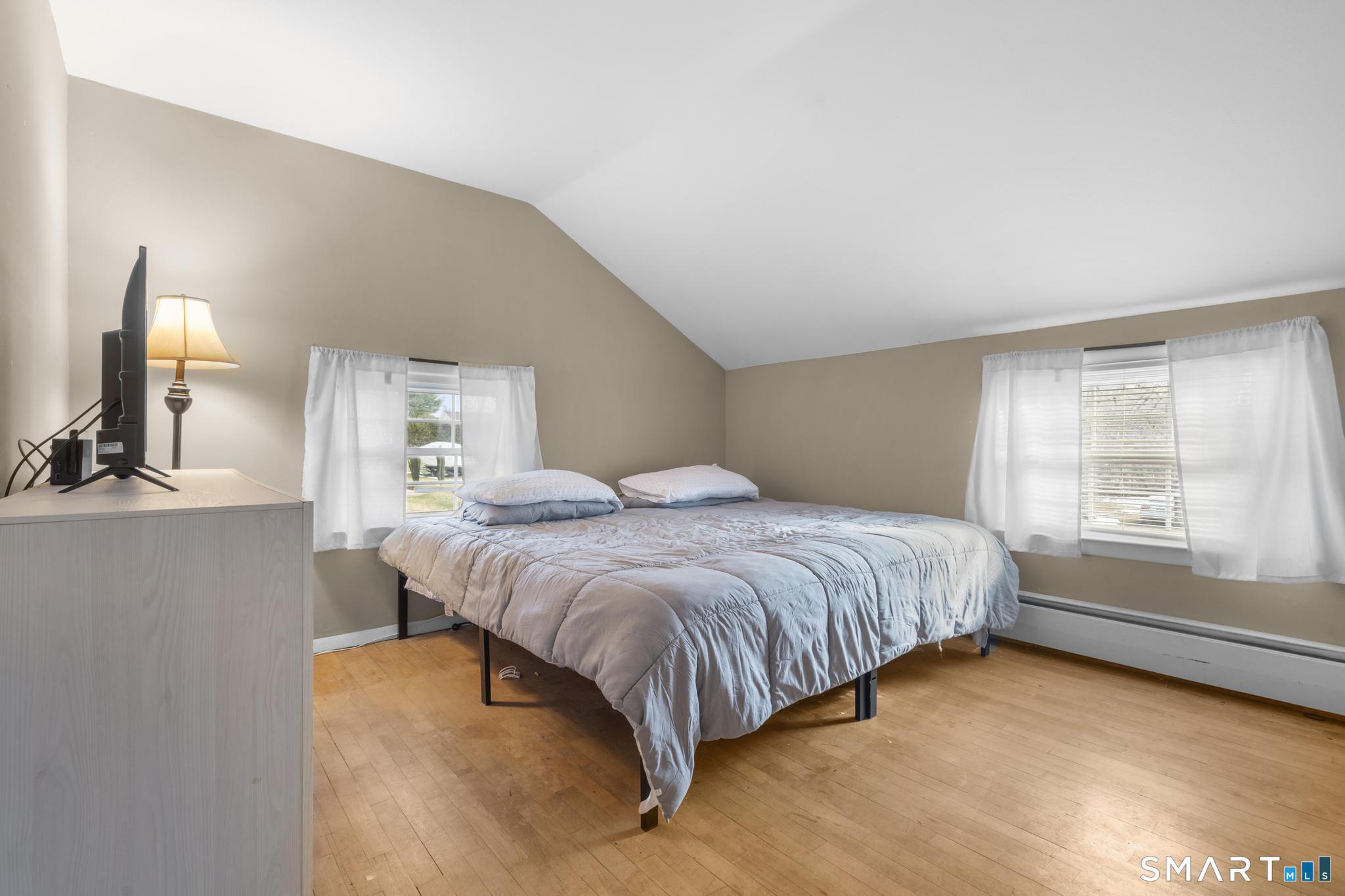 89 Green Meadow Road Milford, CT 06461 - Photo 16 of 31 a spacious bedroom with a bed and window