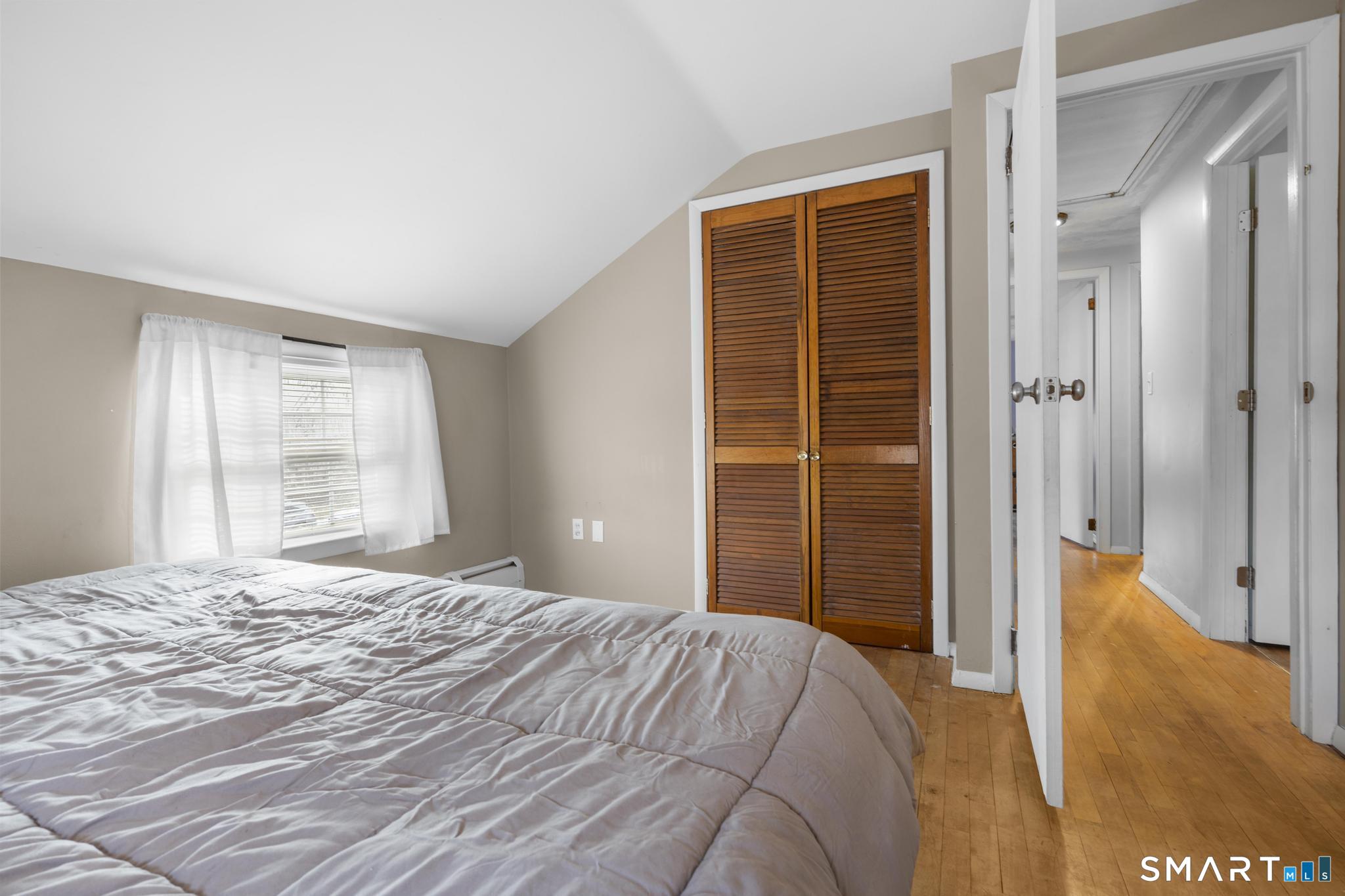 89 Green Meadow Road Milford, CT 06461 - Photo 17 of 31 a bedroom with a bed and a window