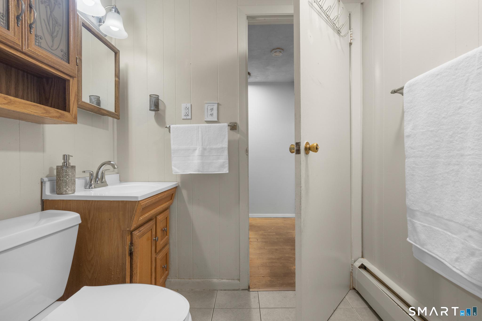 89 Green Meadow Road Milford, CT 06461 - Photo 19 of 31 a bathroom with a toilet sink and shower