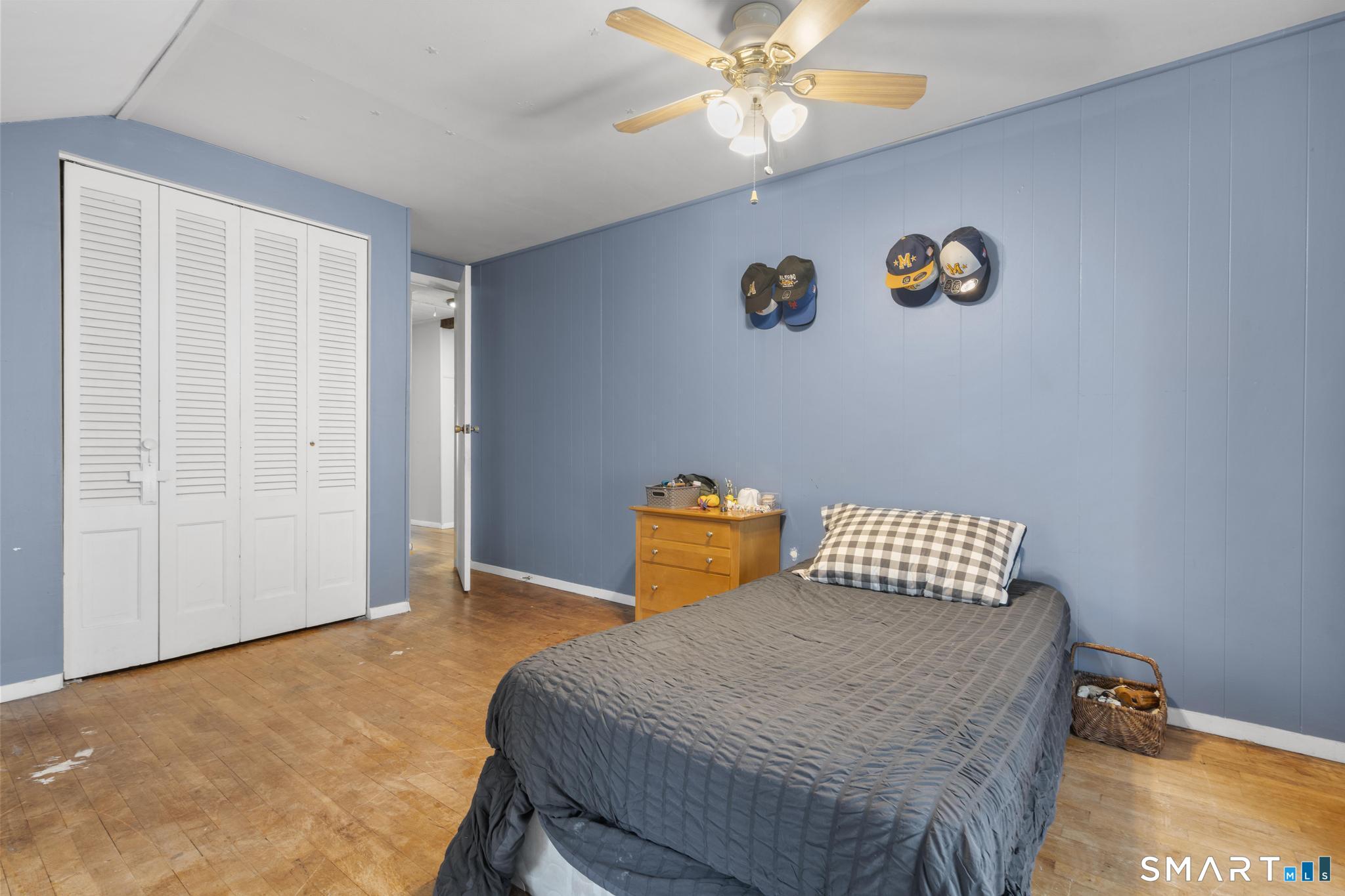 89 Green Meadow Road Milford, CT 06461 - Photo 23 of 31 a bedroom with a bed and a chandelier