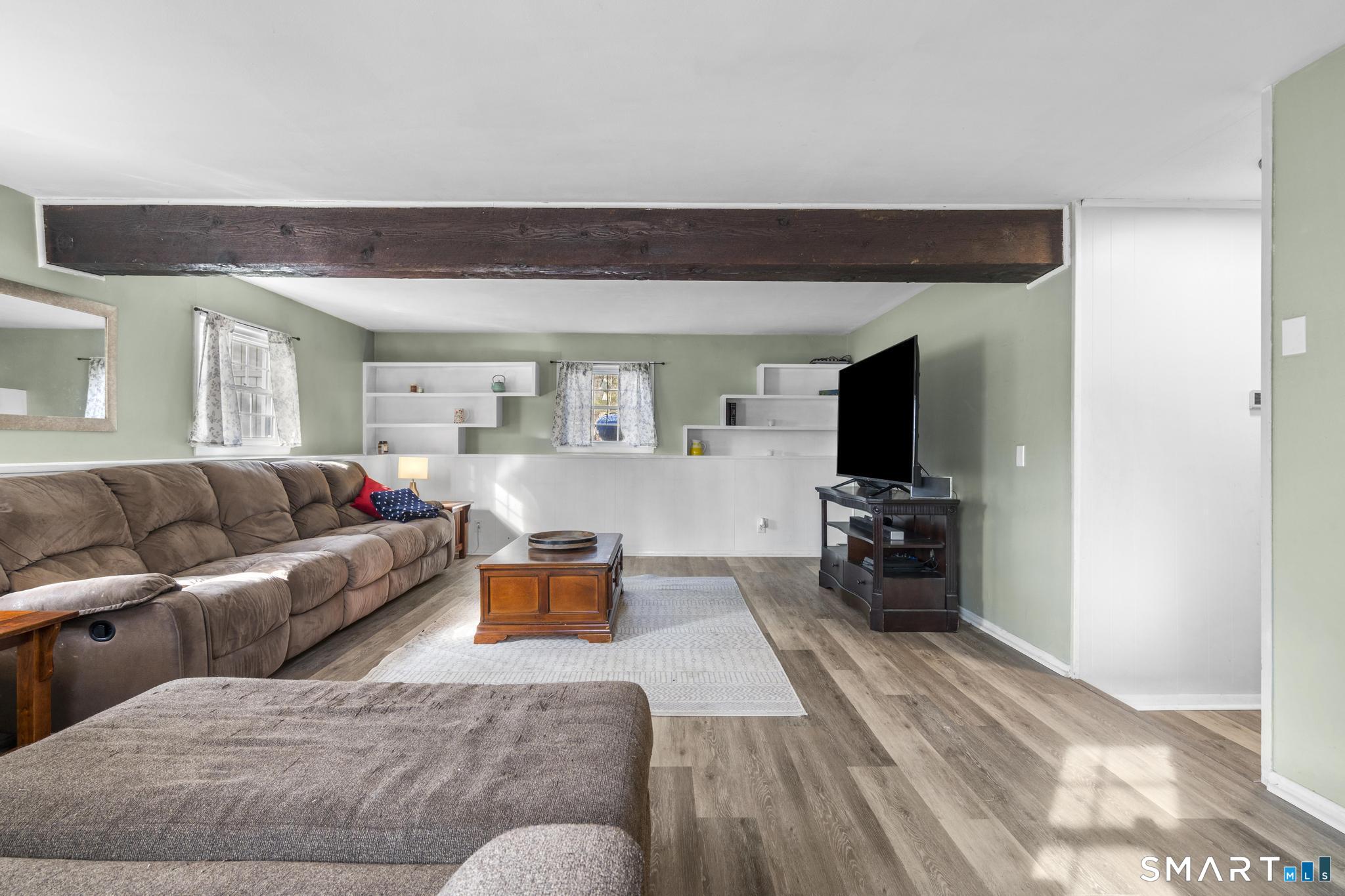 89 Green Meadow Road Milford, CT 06461 - Photo 7 of 31 a living room with furniture and a flat screen tv