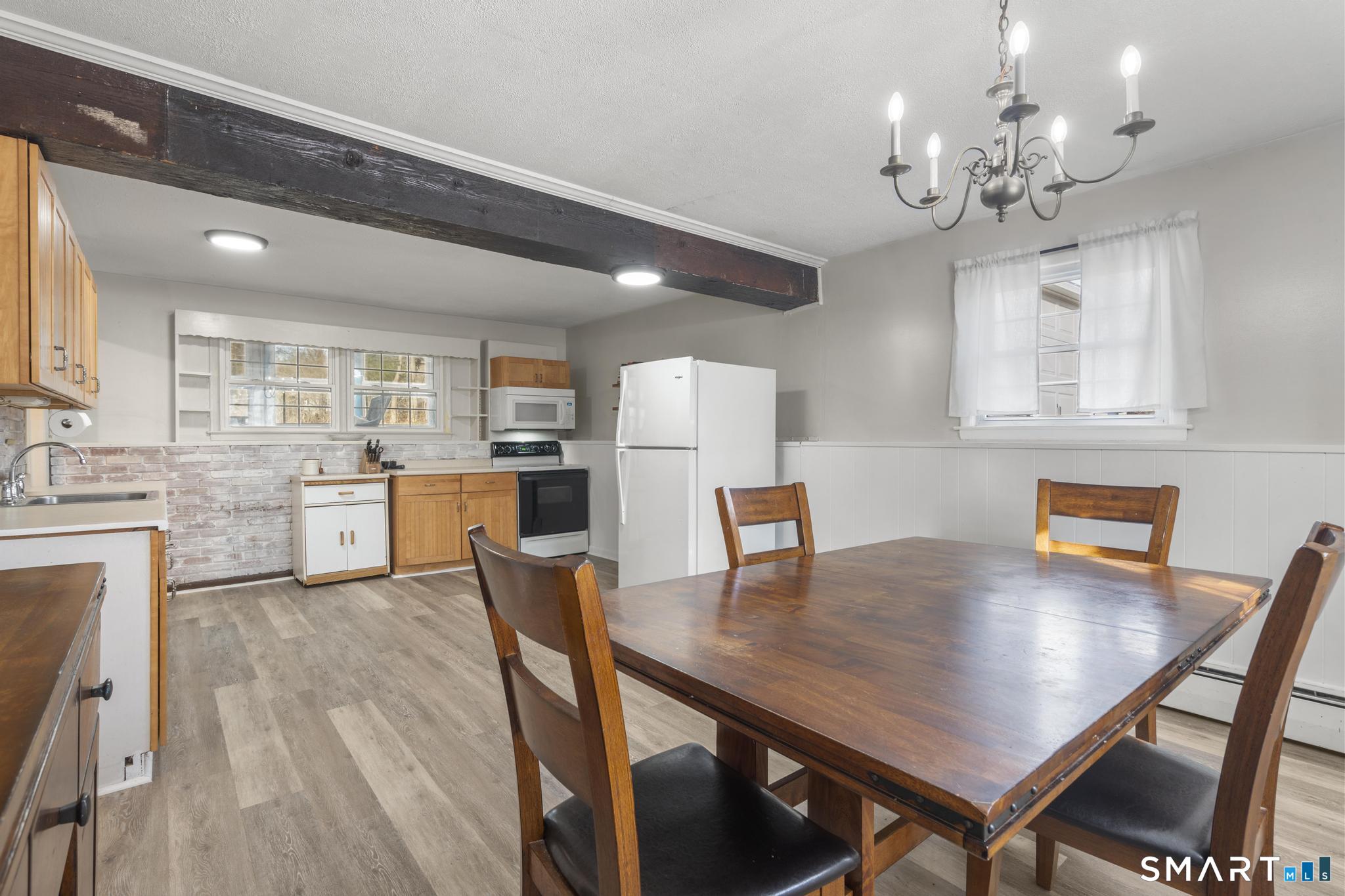 89 Green Meadow Road Milford, CT 06461 - Photo 10 of 31 a view of a dining room with furniture and a chandelier