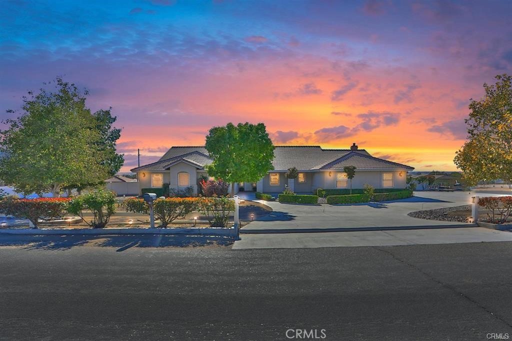 14770 Kokomo Road Apple Valley, CA 92307 - Photo 1 of 1 a city street lined with buildings and trees