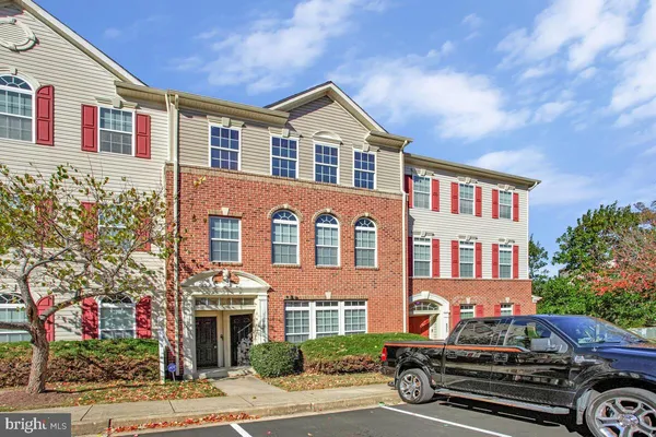a front view of a residential apartment building with a yard